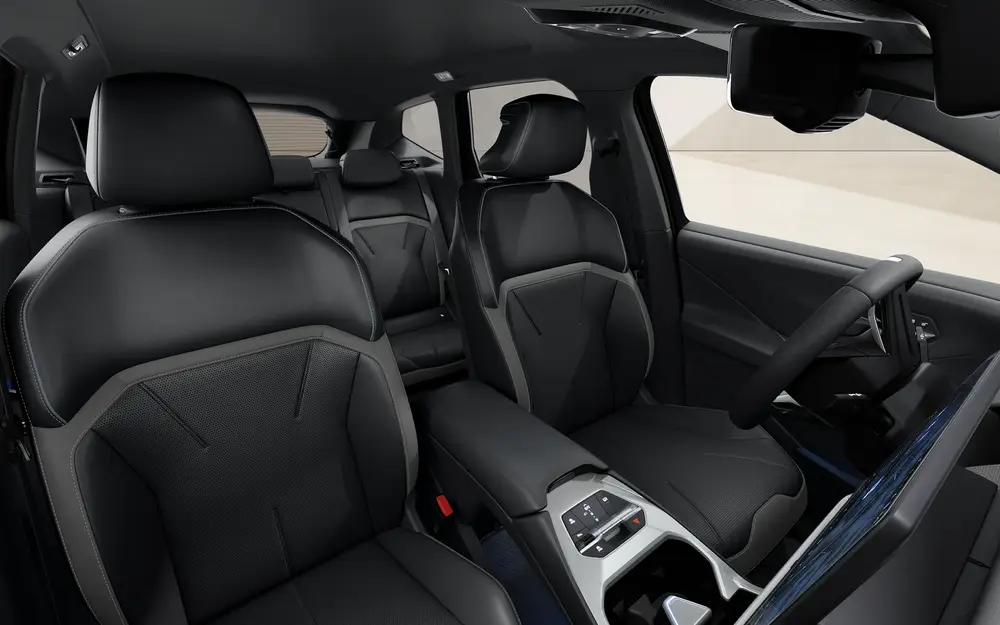 Innenraum des BMW iX3 Neue Klasse mit schwarzen Sportsitzen, moderner Mittelkonsole, klarer Linienführung und großzügigem Raumgefühl im vorderen und hinteren Sitzbereich vor transparentem Hintergrund.
